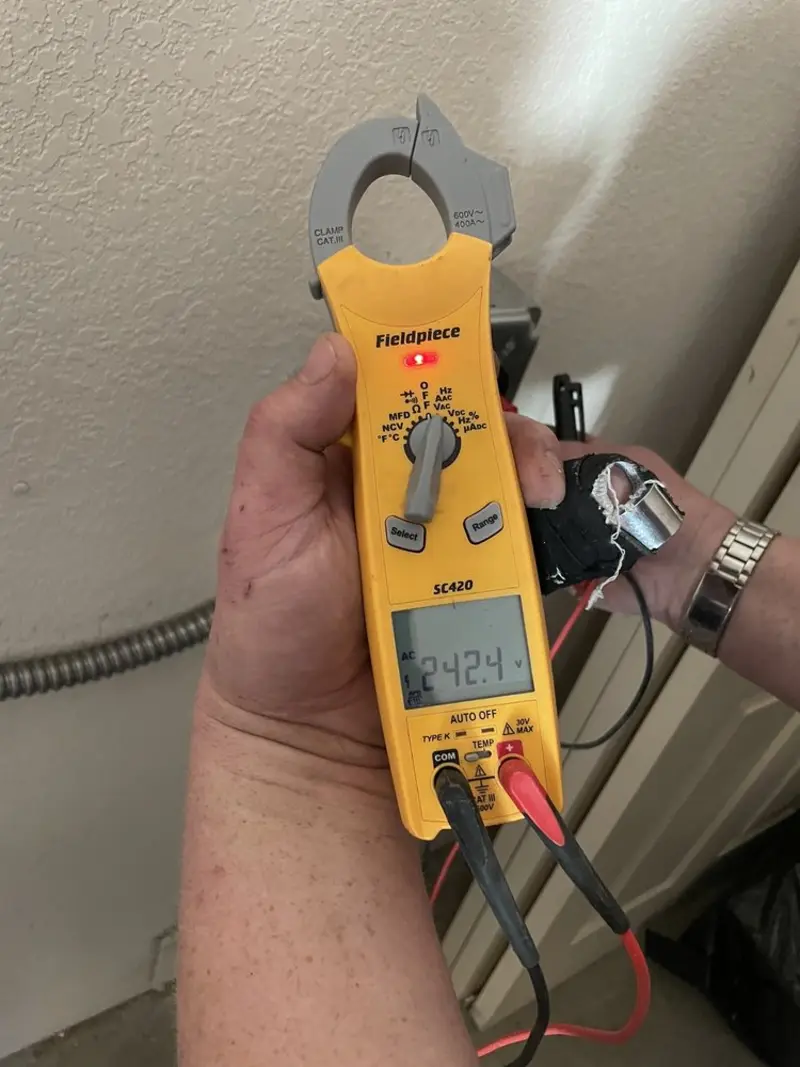 Voltage testing with clamp meter during Ceiling Fan Installation in Clarkstown